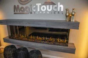 photo of a virtual electrci fireplace under a sign that reads magic touch mechanical